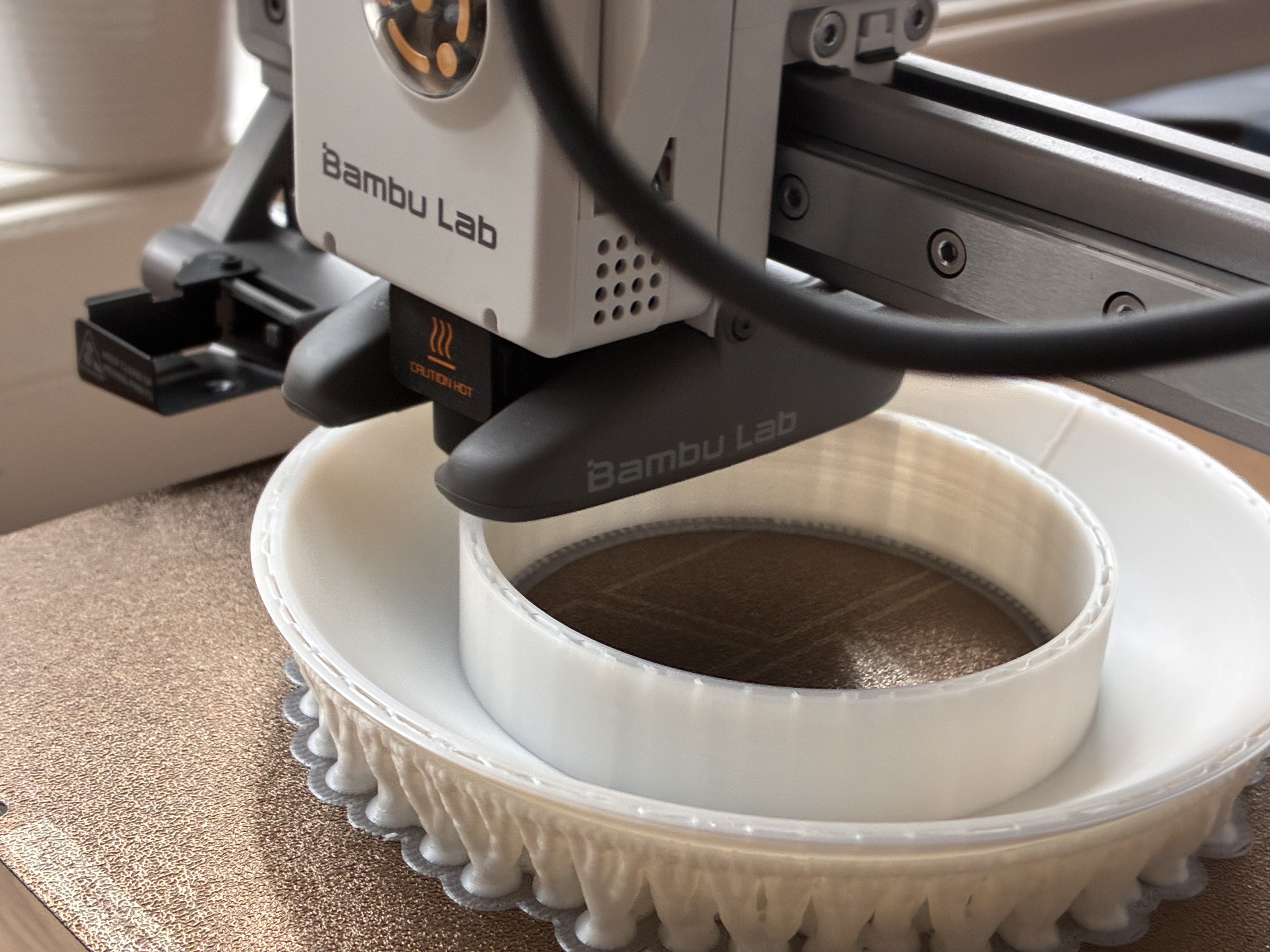A 3D printer producing a large white development prototype